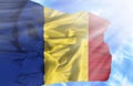 Romania waving flag against blue sky with sunrays Royalty Free Stock Photo