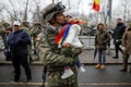 Romanian army soldier holds his child in his arms during the Romanian National Day military parade