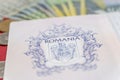 Romanian concept. The Romanian passport and Romanian banknotes/coins on a blue and red background. Coloseup of Romanian Passport Royalty Free Stock Photo