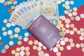 Romanian concept. The Romanian passport and Romanian banknotes/coins on a blue and red background. Coloseup of Romanian Passport Royalty Free Stock Photo