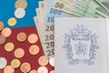 Romanian concept. The Romanian passport and Romanian banknotes/coins on a blue and red background. Coloseup of Romanian Passport Royalty Free Stock Photo