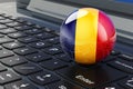 Romanian flag on laptop keyboard. Online business, education, shopping in Romania concept. 3D rendering