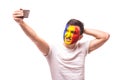 Romanian football fan take selfie photo with phone on white background. Royalty Free Stock Photo