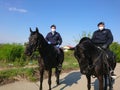 The Romanian Gendarmerie on horses wearing face masks . Police on patrol ensuring that the law imposed by the emergency state is