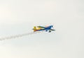 The Romanian Hawks Team pilot with his colored airplane training in the blue sky Royalty Free Stock Photo
