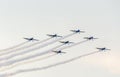 The Romanian Hawks Team pilots with their colored airplanes training in the blue sky. Royalty Free Stock Photo