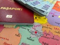 Romanian 100 Lei banknotes and a Romanian EU Passport on a map of Romanian Counties Royalty Free Stock Photo