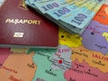 Romanian 100 Lei banknotes and a Romanian EU Passport on a map of Romanian Counties Royalty Free Stock Photo
