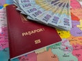 Romanian 100 Lei banknotes and a Romanian EU Passport on a map of Romanian Counties Royalty Free Stock Photo