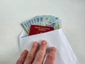 Romanian Lei 100 RON bank notes being handed over in an envelope Royalty Free Stock Photo