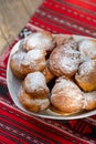 Romanian mini doughnuts on a plate on red traditional cloth