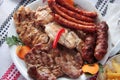 Romanian mixed grilled plate with beef, pork, chicken and traditional thin sausages Royalty Free Stock Photo