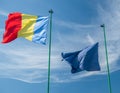 Romanian national flag an the flag of European Union waving against clear blue sky Royalty Free Stock Photo