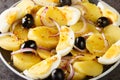 Romanian oriental potato salad with onions, olives and boiled eggs close-up on a plate. horizontal Royalty Free Stock Photo