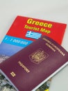 Romanian passport on Greece tourist map Royalty Free Stock Photo