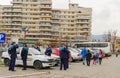 Romanian policemen stand near a police car