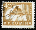 MOSCOW, RUSSIA - APRIL 2, 2017: A post stamp printed in Romania shows Piano in hall and books, circa 1960