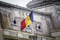 Romanian revolutionary flag with a hole, also called Drapelul Romaniei waiving on a flagpole of Timisoara. It is the national Royalty Free Stock Photo
