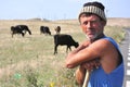 Romanian shepherd with cows in the countryside Royalty Free Stock Photo