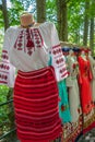 Romanian traditional costumes on mannequins and hangers shown outdoors Royalty Free Stock Photo