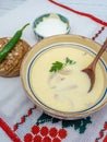 Romanian dish tripe soup with hot peppers, sour cream and bread