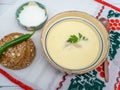 Romanian dish tripe soup with hot peppers, sour cream and bread