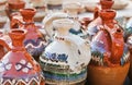 Romanian traditional pottery handcrafted mugs at a souvenir shop. Romanian traditional handcrafted pottery jugs to be sold Royalty Free Stock Photo