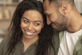 Romantic african american spouses bonding at home, loving black man and woman embracing, sitting on sofa at home Royalty Free Stock Photo