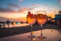 Romantic ambiance two cocktails, beach party blur, colorful sunset sky Royalty Free Stock Photo