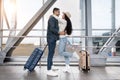 Romantic Arab Couple Hugging While Waiting For Flight In Airport Terminal Royalty Free Stock Photo