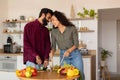 Romantic arab spouses bonding, preparing meal together, loving husband and wife cooking, kitchen interior, copy space Royalty Free Stock Photo