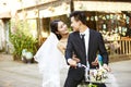 Romantic asian newly-wed riding a bicycle Royalty Free Stock Photo