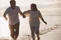 The romantic Asian senior couple hand in hand while walking on summer beach sunset. Travel leisure and activity after retirement Royalty Free Stock Photo