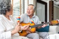 Romantic Asian senior Couple playing acoustic guitar Royalty Free Stock Photo