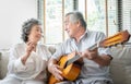 Romantic Asian senior Couple singing and playing acoustic guitar together Royalty Free Stock Photo