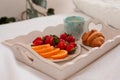 Romantic atmosphere in bedroom, sweet breakfast on tray