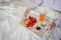 Romantic atmosphere in bedroom, sweet breakfast on tray