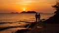 A romantic atmosphere with a couple walking along a deserted beach in the rays of sunset Royalty Free Stock Photo