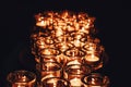 Romantic atmosphere, many small, lit candles on the table. Dark background Royalty Free Stock Photo