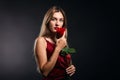 Romantic attractive cute woman in red fashion dress got a flower during a date Royalty Free Stock Photo