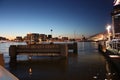 Romantic autumnal evening panorama over the canal waters of the Dutch metropolitan city of Amsterdam, among the lights and Royalty Free Stock Photo