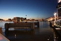 Romantic autumnal evening panorama over the canal waters of the Dutch metropolitan city of Amsterdam, among the lights and Royalty Free Stock Photo