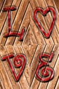 Romantic background on antique wood and red word love impressed above