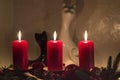 Romantic background with candles, cats statues and flame in darkness