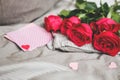 Romantic background with copy space. Beautiful roses and Valentine card with heart. Selective focus Royalty Free Stock Photo