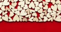 Romantic background of dozens of tiny wooden hearts on a red card. For love, romance, or Valentine`s Day