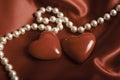 Beautiful pearls jewerly and two hearts like romantic background