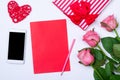 Romantic background: smartphone, flowers roses and blank sheet o