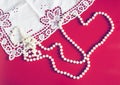 background for valentine`s day with pearl necklace heart and lace on red background Royalty Free Stock Photo