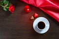 Romantic background with wedding ring, rose flowers, cup of coffee and chocolate candy Royalty Free Stock Photo